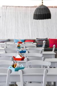a group of white chairs with toys sitting on them at Fisilanis Beachfront Hotel in Logaras
