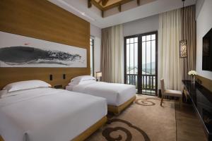 Voodi või voodid majutusasutuse Banyan Tree Huangshan toas