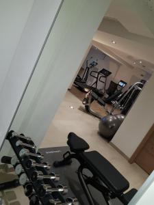 a gym with a row of treadmills and exercise machines at Hotel Vergeiner in Seefeld in Tirol