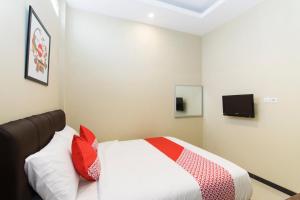 A bed or beds in a room at SUPER OYO 890 Dewi Fortuna Guest House