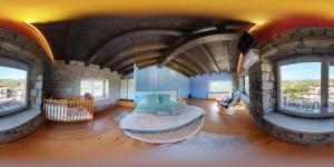 a room with a large room with a stone wall at Casa Rural La Abadia-Apartamentos in Graus
