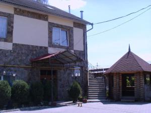 a brick building with a sign on the front of it at Dvorik in Chernivtsi