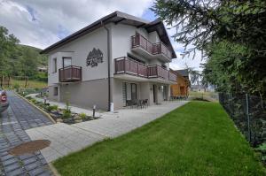 a building with balconies on the side of it at Apartamenty Skalite Szczyrk ul Woźna 14 in Szczyrk