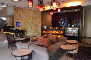 a lobby with a couch and tables and a bakery at El Cielito Inn - Sta. Rosa in Santa Rosa