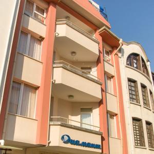 a building with a sign on the side of it at Penzion DIAMANT in Primorsko