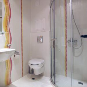 a bathroom with a shower with a toilet and a sink at Penzion DIAMANT in Primorsko