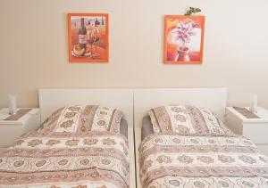 トリーアにあるFerienwohnung Cramesのベッドルーム1室(ベッド1台付)が備わります。壁に2枚の写真が飾られています。