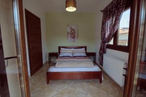 a bedroom with a bed and a window at sunny in Ayios Nikolaos Sithonia