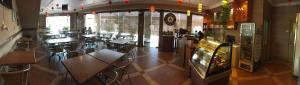 a restaurant with tables and chairs in a room at Harbour View Hotel Sekinchan in Sekinchan
