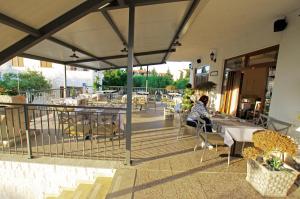 a woman sitting at a table on a patio at Slanica studio ID 816 by HeartofDalmatia in Murter +29 photos