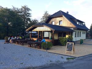 a building with people sitting at tables in front of it at Rychlebská bašta in Černá Voda