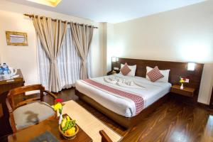 A bed or beds in a room at Kathmandu Suite Home