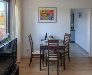 a dining room with a table and chairs at Apartamenty Łagiewniki in Krakow