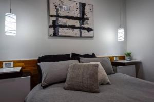 a bedroom with a bed with two pillows at BENGALEE EXECUTIVE TOWNHOUSE- MODERN & STYLISH in Mount Gambier