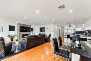 a living room with leather chairs and a glass table at BENGALEE EXECUTIVE TOWNHOUSE- MODERN & STYLISH in Mount Gambier +6 photos