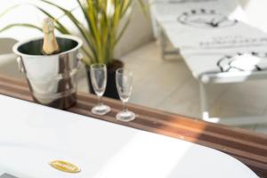 a tray with two glasses and a bottle of champagne at Hotel Ambassador in Rimini
