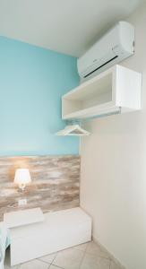 a white room with a painting of the ocean at Taormina Beach House in Mazzeo +28 photos