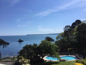 a view of a body of water with a swimming pool at The Osborne Apartments in Torquay