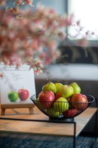 a bowl of apples sitting on a table at Bilderberg Garden Hotel in Amsterdam
