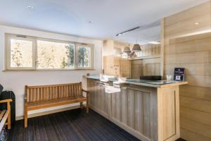 a kitchen with a counter and a bench in it at Résidence Pierre & Vacances Le Golf in Méribel