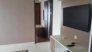 a room with a flat screen tv on a wall at Ruby Apartment #2 in Yogyakarta