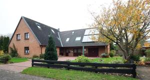 a large brick house with a black roof at Haus Fabricius in Tating