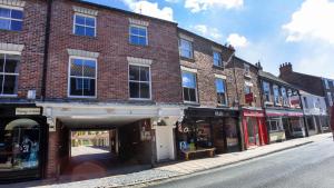 een bakstenen gebouw in een stadsstraat met winkels bij Malt Shovel Court in York