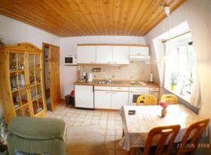 a kitchen with a table and chairs and a dining room at Hus bi de Strandlöper in Böhl