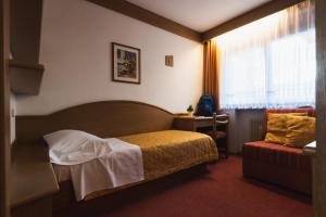 Postel nebo postele na pokoji v ubytování Hotel Catinaccio