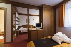 Postel nebo postele na pokoji v ubytování Hotel Catinaccio