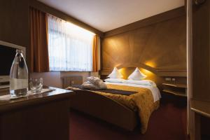 Postel nebo postele na pokoji v ubytování Hotel Catinaccio