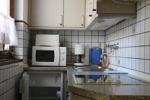 a kitchen with a sink and a microwave at Haus Kretschmar in Böhl