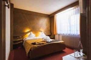 Postel nebo postele na pokoji v ubytování Hotel Catinaccio