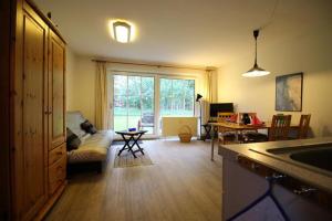 a kitchen and living room with a couch and a table at Ferienwohnung Remuß in Garding