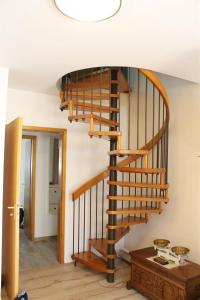 a wooden spiral staircase in a living room at Ferienwohnung Oosting in Sankt Peter-Ording