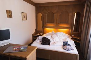 Postel nebo postele na pokoji v ubytování Hotel Catinaccio