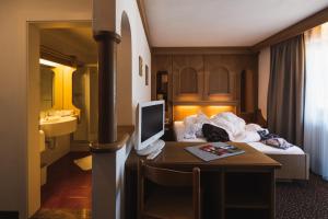 Postel nebo postele na pokoji v ubytování Hotel Catinaccio