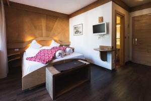 Postel nebo postele na pokoji v ubytování Hotel Catinaccio