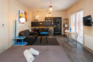a living room with a couch and a kitchen at Apartmány Kopacka in Svitavy