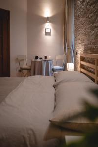 a bedroom with a bed and a table in a room at Casa Lena B&B in Naples