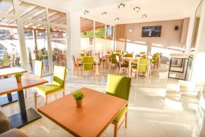 a restaurant with tables and chairs and windows at Villa Kotlar in Ohrid