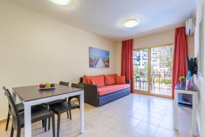 a living room with a couch and a table at Rentalmar Pins Marina in Cambrils