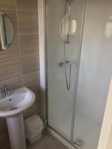 a bathroom with a shower and a sink at The Loft Guest Apartment in Portstewart