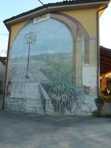 een muurschildering aan de zijkant van een gebouw bij Agriturismo San Martino in Castiglione Tinella