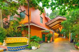 an orange building with a walkway in front of it at Mayfair Rourkela in Panposh