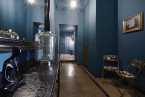a blue room with a table and two chairs at Look To Viphouse in Turin