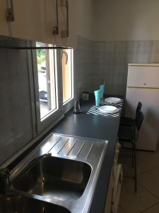 a kitchen counter with a sink and a window at Tra S.Orsola e Fiera in Bologna