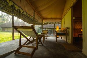 a room with chairs and a table in a tent at The Barefoot At Havelock in Havelock Island