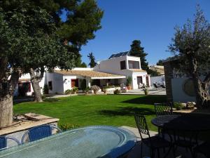 a house with a table and chairs in a yard at Mi Naranjo (heated pool) in Orihuela Costa
