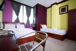 Ένα ή περισσότερα κρεβάτια σε δωμάτιο στο Saujana City Hotel +27 φωτογραφίες